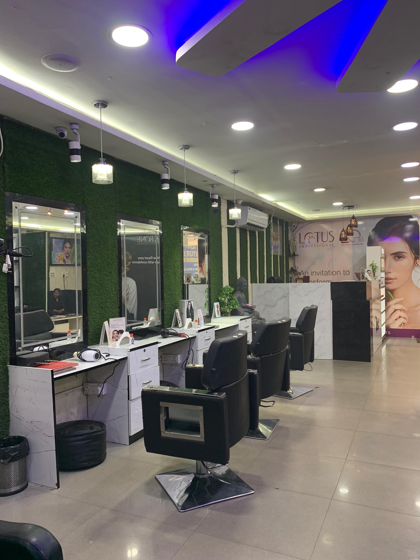Row of styling chairs and lit mirrors inside Touch of Class